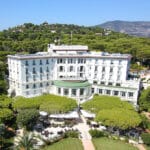 An elegant hotel, perfect for a romantic wedding, nestled in a lush garden, representing ceremonial excellence on the French Riviera. &#039;By Mademoiselle C&#039; specializes in planning luxury, bespoke weddings in exceptional locations such as this, offering an unforgettable experience for a grand celebration. With breathtaking views of the surrounding mountains, every detail of this unique event is taken care of.