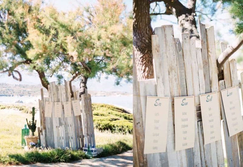 Un élégant panneau de bienvenue en bois, niché sous un arbre, invite les invités à un mariage romantique sur la Côte d'Azur. Ce cadre idyllique, entouré de verdure et de vues sur la mer, est le lieu parfait pour une célébration grandiose. Avec une organisation sur mesure par 'By Mademoiselle C', chaque détail de cet événement unique reflète le luxe et le raffinement d'une cérémonie de rêve. Le mélange de nature et d'élégance