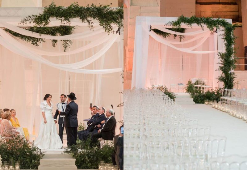 Romantic wedding ceremony organized by By Mademoiselle C, featuring an elegant couple under delicate drapery in a sophisticated setting. This grandiose celebration, held in an exceptional location, embodies the luxury of Provence, the French Riviera and Corsica. Guests, dressed to the nines, attend this bespoke event, surrounded by greenery and soft light, creating an intimate and intimate atmosphere.