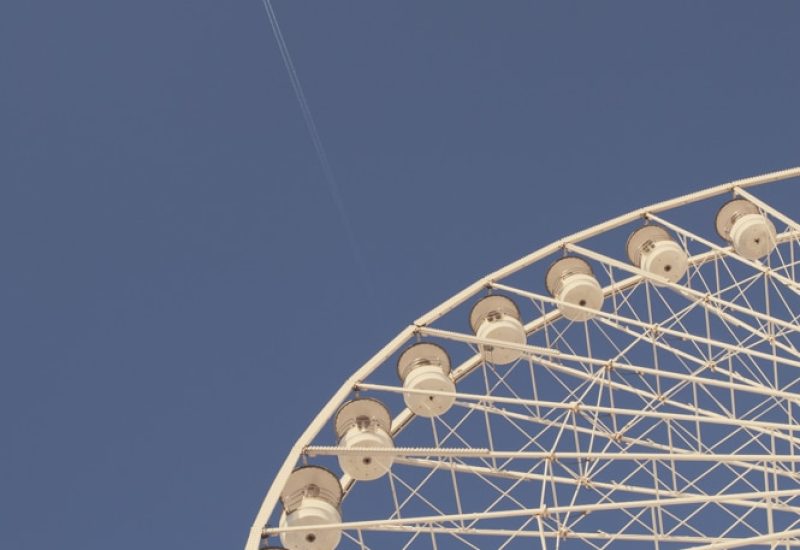 Wheel of fortune against a blue sky, symbolizing the elegance and romance of a luxury wedding in Provence, the French Riviera and Corsica. Perfect for a grand celebration, this image evokes bespoke events in exceptional locations, creating a sophisticated atmosphere for a dream wedding. The surrounding landscapes add a unique touch, ideal for an unforgettable private event, carefully orchestrated by By Mademoiselle C