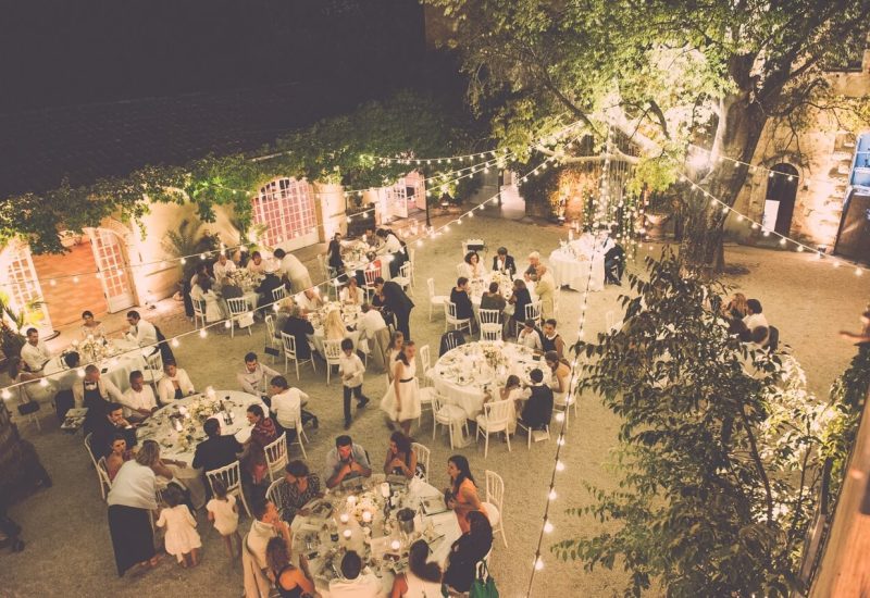 An elegant outdoor wedding dinner, organized by By Mademoiselle C, in a romantic and sophisticated setting. Guests enjoy a magical evening under twinkling lights, surrounded by the beauty of a private estate in Provence. This bespoke celebration embodies the luxury and exclusivity of a dream wedding, with tables delicately set for an unforgettable experience. It's a unique event that transforms every moment.