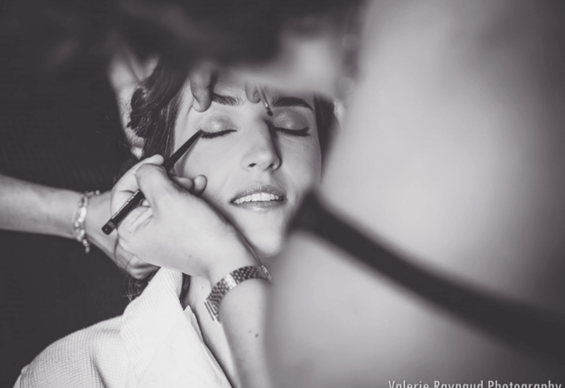 An intimate moment of preparation for a bride in an elegant setting, showcasing the expertise of By Mademoiselle C, wedding planner in Provence, French Riviera and Corsica. This image illustrates the romantic and sophisticated atmosphere of a luxury wedding, where every detail is carefully orchestrated to create a bespoke celebration. The bride, surrounded by professionals, prepares for her big day, embodying the dream of a unique event.