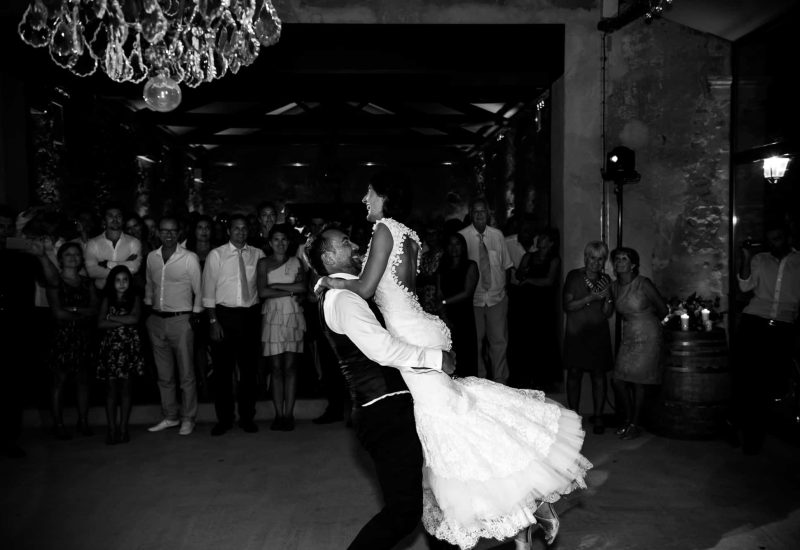 Romantic dancing at a luxurious wedding celebration organized by By Mademoiselle C, showcasing a happy couple amidst captivated guests. This unique moment in an elegant setting illustrates the brand's expertise in planning bespoke weddings in Provence, the French Riviera and Corsica. The refined decor and warm atmosphere create a grand event experience, turning this wedding dream into reality.