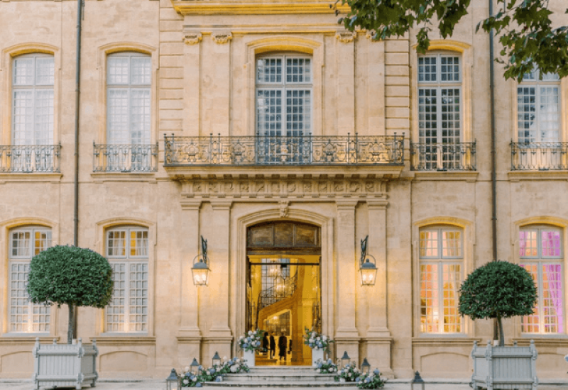 Superb luxury hotel facade, emblematic of Provence, the French Riviera and Corsica, ideal for a romantic wedding. This elegant property, surrounded by carefully tended gardens, embodies the essence of a grand celebration. With its refined architectural details, this space becomes the perfect setting for an exceptional ceremony, tailor-made by By Mademoiselle C. Treat yourself to a unique wedding experience on a private estate, where