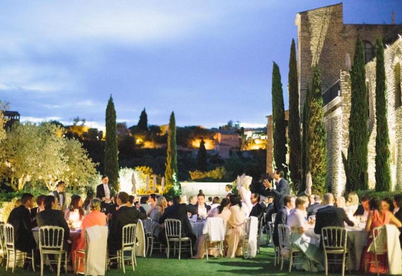 Elegant outdoor reception, organized by By Mademoiselle C, showcasing a luxury wedding in a romantic Provence setting. Guests enjoy a grand banquet under a starry sky, surrounded by cypress trees and breathtaking views of the hills. This unique moment embodies the essence of a grand celebration, with attention to every detail to create a bespoke event in an exceptional private estate.